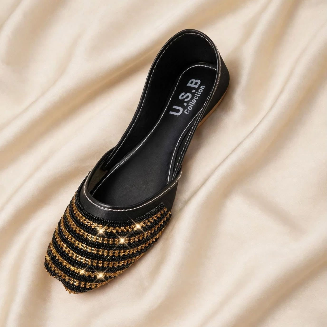 Black Golden Stripes Khussa top view on satin background, Her Footwear