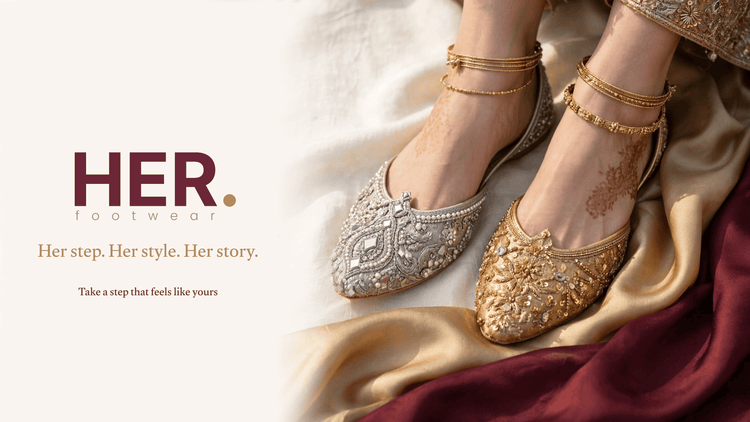 A pair of ornate flat shoes worn on feet with henna, styled with gold bangles and draped satin fabric. The left shoe is silver with intricate beadwork, and the right shoe is gold with matching embroidery.