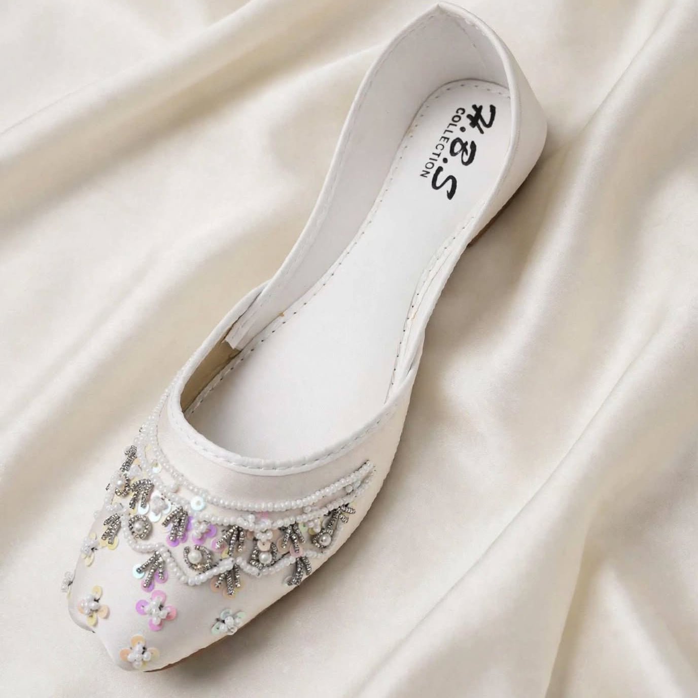 Ivory Rosette Bridal Khussa styled with flowers, Her Footwear